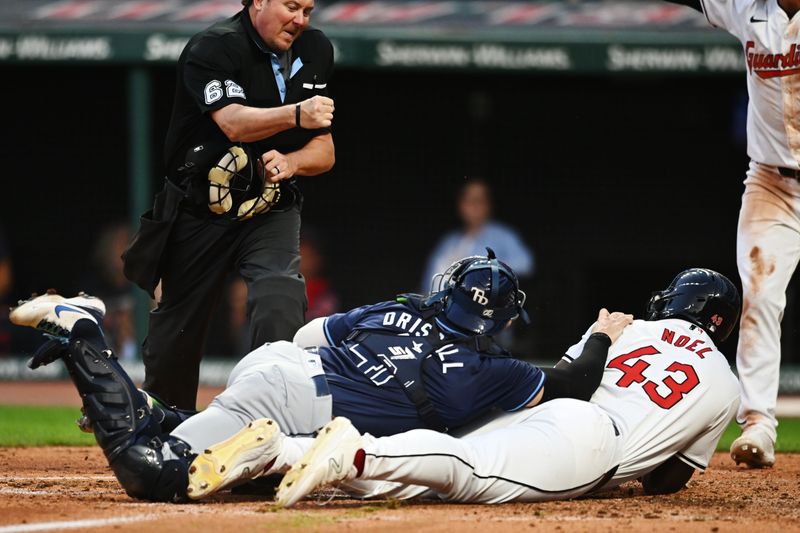 Sep 14, 2024; Cleveland, Ohio, USA; Tampa Bay Rays catcher Logan Driscoll (41) and Cleveland Guardians right fielder Jhonkensy Noel (43) look for the call from home plate umpire Chad Whitson during the sixth inning at Progressive Field. Noel was out on the play. Mandatory Credit: Ken Blaze-Imagn Images