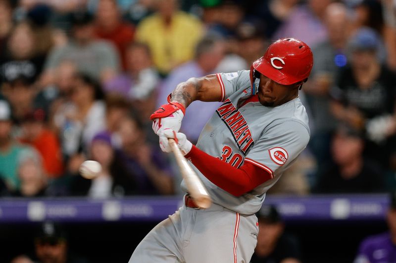 Jun 3, 2024; Denver, Colorado, USA; Cincinnati Reds left fielder Will Benson (30) hits a two RBI triple in the fourth inning against the Colorado Rockies at Coors Field. Mandatory Credit: Isaiah J. Downing-USA TODAY Sports