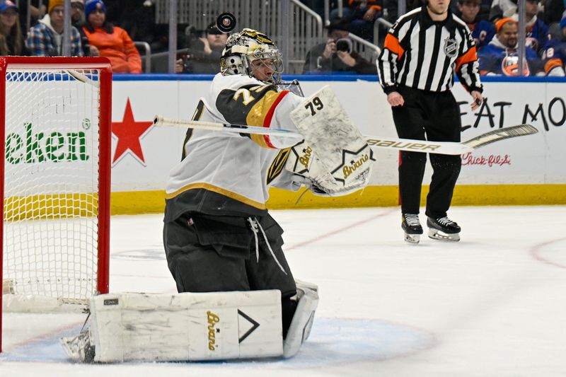 Dec 9, 2025; Elmont, New York, USA; Vegas Golden Knights goaltender Carter Hart (79) makes a save against the New York Islanders during the second period at UBS Arena. Mandatory Credit: Dennis Schneidler-Imagn Images
