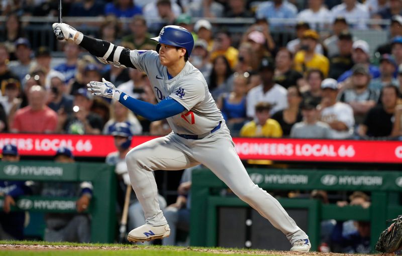 Jun 4, 2024; Pittsburgh, Pennsylvania, USA;  Los Angeles Dodgers designated hitter Shohei Ohtani (17) hits a single against the Pittsburgh Pirates during the eighth inning at PNC Park. The Pirates shutout the Dodgers 1-0. Mandatory Credit: Charles LeClaire-USA TODAY Sports