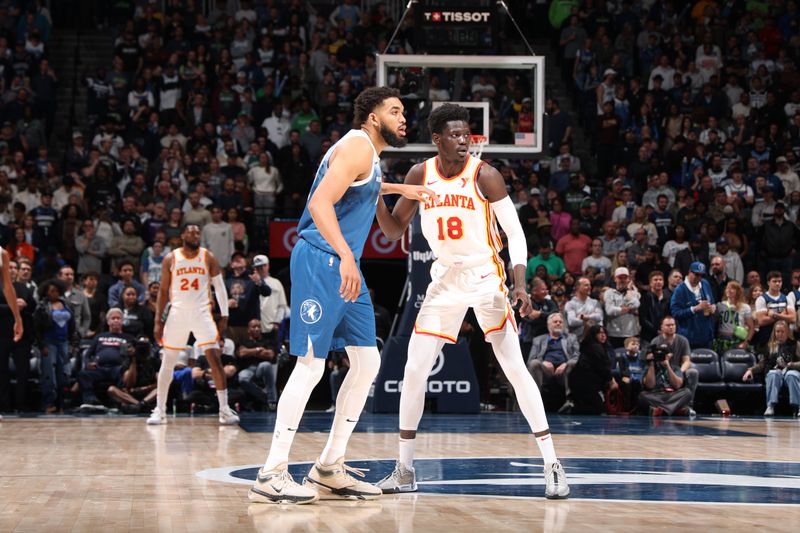 MINNEAPOLIS, MN -  APRIL 12:  Karl-Anthony Towns #32 of the Minnesota Timberwolves plays defensed during the game Mouhamed Gueye #18 of the Atlanta Hawks on April 12, 2024 at Target Center in Minneapolis, Minnesota. NOTE TO USER: User expressly acknowledges and agrees that, by downloading and or using this Photograph, user is consenting to the terms and conditions of the Getty Images License Agreement. Mandatory Copyright Notice: Copyright 2024 NBAE (Photo by David Sherman/NBAE via Getty Images)