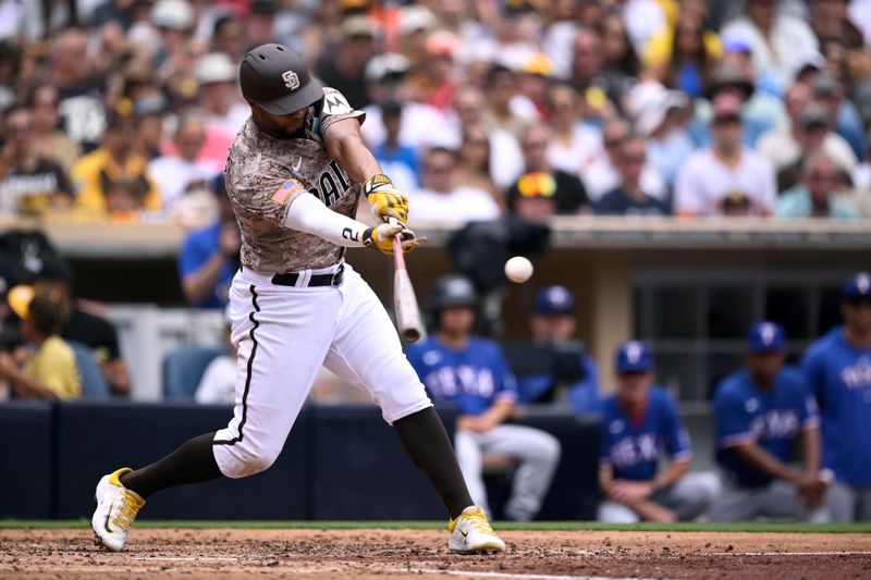 Jul 30, 2023; San Diego, California, USA; San Diego Padres shortstop Xander Bogaerts (2) hits a sacrifice fly against the Texas Rangers during the third inning at Petco Park. Mandatory Credit: Orlando Ramirez-USA TODAY Sports