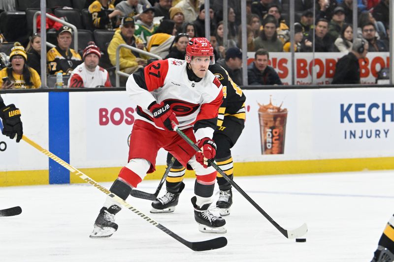 Nov 1, 2025; Boston, Massachusetts, USA; Carolina Hurricanes left wing Nikolaj Ehlers (27) looks to pass the puck during the second period against the Boston Bruins at TD Garden. Mandatory Credit: Eric Canha-Imagn Images