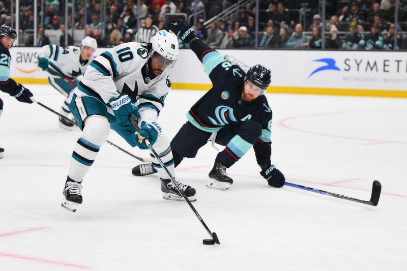 Nov 22, 2023; Seattle, Washington, USA; San Jose Sharks left wing Anthony Duclair (10) advances the puck against the Seattle Kraken during the first period at Climate Pledge Arena. Mandatory Credit: Steven Bisig-USA TODAY Sports