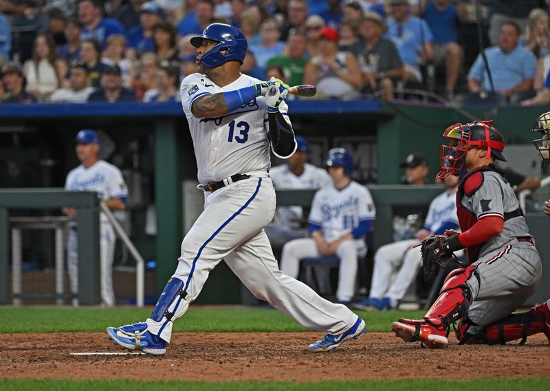 Jul 29, 2023; Kansas City, Missouri, USA;  Kansas City Royals catcher Salvador Perez (13) in an RBI single during the sixth inning against the Minnesota Twins at Kauffman Stadium. Mandatory Credit: Peter Aiken-USA TODAY Sports