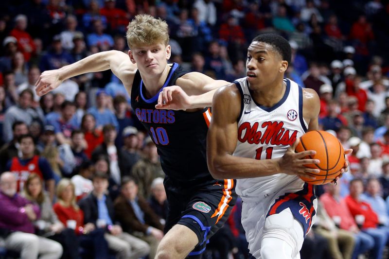 Jan 10, 2024; Oxford, Mississippi, USA; Mississippi Rebels guard Matthew Murrell (11) drives to the basket as Florida Gators forward Thomas Haugh (10) defends during the second half at The Sandy and John Black Pavilion at Ole Miss. Mandatory Credit: Petre Thomas-USA TODAY Sports