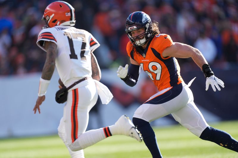 Denver Broncos linebacker Alex Singleton (49) pursues Cleveland Browns quarterback Dorian Thompson-Robinson (17) in the first half of an NFL football game Sunday, Nov. 26, 2023, in Denver. (AP Photo/David Zalubowski)