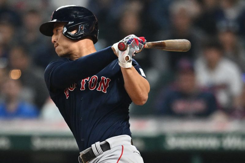 Jun 6, 2023; Cleveland, Ohio, USA; Boston Red Sox pinch hitter Rob Refsnyder (30) hits an RBI single during the eighth inning against the Cleveland Guardians at Progressive Field. Mandatory Credit: Ken Blaze-USA TODAY Sports