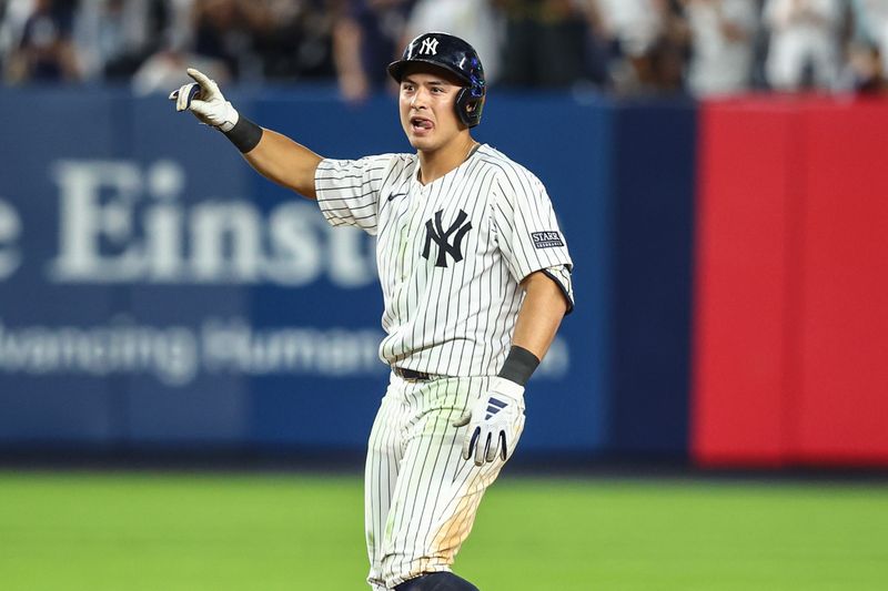 Jun 19, 2024; Bronx, New York, USA;  New York Yankees shortstop Anthony Volpe (11) reacts after hitting a double in the ninth inning against the Baltimore Orioles at Yankee Stadium. Mandatory Credit: Wendell Cruz-USA TODAY Sports