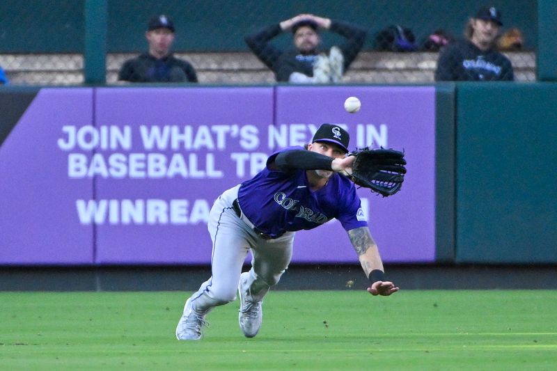 Jun 6, 2024; St. Louis, Missouri, USA;  Colorado Rockies left fielder Jake Cave (11) dives and catches a line drive against the St. Louis Cardinals during the first inning at Busch Stadium. Mandatory Credit: Jeff Curry-USA TODAY Sports