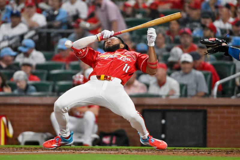 Jun 6, 2025; St. Louis, Missouri, USA;  St. Louis Cardinals center fielder Victor Scott II (11) avoids getting hit as he lays down a sacrifice bunt against the Los Angeles Dodgers during the fifth inning at Busch Stadium. Mandatory Credit: Jeff Curry-Imagn Images