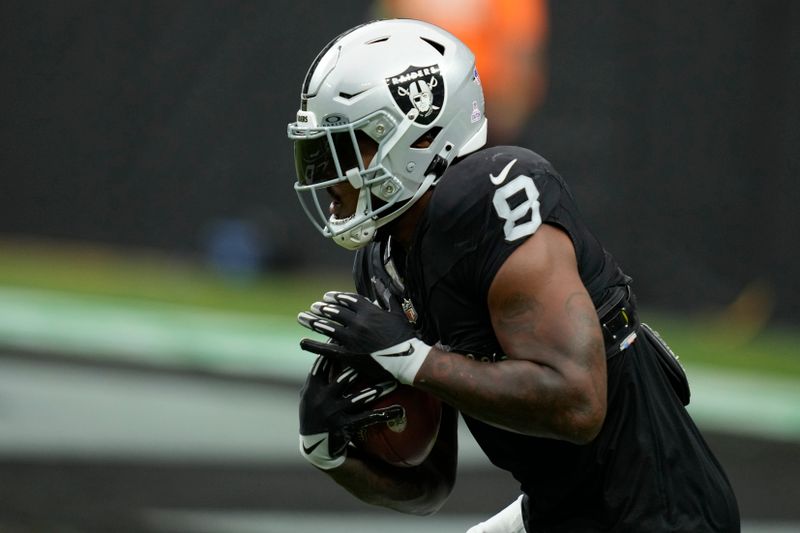 Las Vegas Raiders running back Josh Jacobs (8) warms up before an NFL football game against the New England Patriots, Sunday, Oct. 15, 2023, in Las Vegas. (AP Photo/John Locher)