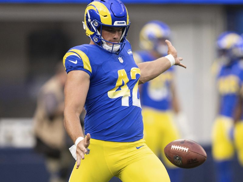 Los Angeles Rams punter Ethan Evans (42) punts before an NFL preseason football game against the Las Vegas Raiders, Saturday, Aug. 19, 2023, in Inglewood, Calif. (AP Photo/Kyusung Gong)