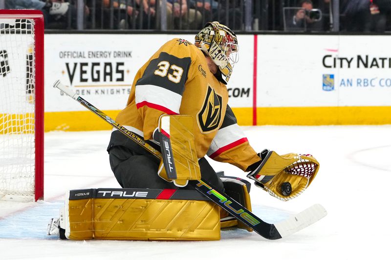 Apr 18, 2024; Las Vegas, Nevada, USA; Vegas Golden Knights goaltender Adin Hill (33) makes a glove save against the Anaheim Ducks during the first period at T-Mobile Arena. Mandatory Credit: Stephen R. Sylvanie-USA TODAY Sports