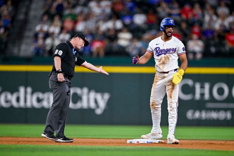 Sep 5, 2024; Arlington, Texas, USA; Texas Rangers center fielder Leody Taveras (3) argues a call with umpire Sean Barber (29) during the second inning at Globe Life Field. Mandatory Credit: Jerome Miron-Imagn Images