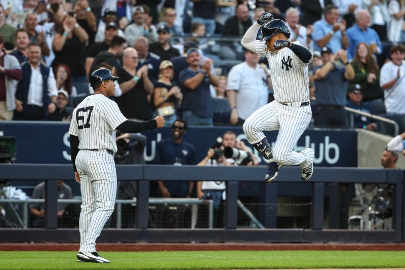 Aug 21, 2024; Bronx, New York, USA;  New York Yankees right fielder Juan Soto (22) celebrates with third base coach Luis Rojas (67) after hitting a two run home run in the first inning against the Cleveland Guardians at Yankee Stadium. Mandatory Credit: Wendell Cruz-USA TODAY Sports