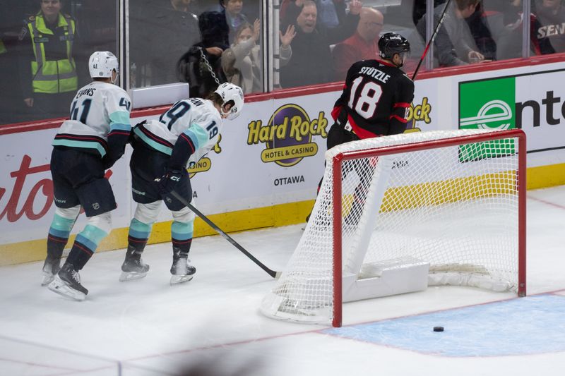 Nov 2, 2024; Ottawa, Ontario, CAN; Ottawa Senators center Tim Stutzle (18) scores an empty net goal in the third period against the Seattle Kraken at the Canadian Tire Centre. Mandatory Credit: Marc DesRosiers-Imagn Images