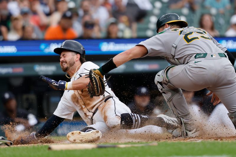 Jun 26, 2025; Detroit, Michigan, USA;  Detroit Tigers outfielder Zach McKinstry (39) is tagged out at home by Athletics catcher Austin Wynns (29) in the sixth inning at Comerica Park. Mandatory Credit: Rick Osentoski-Imagn Images