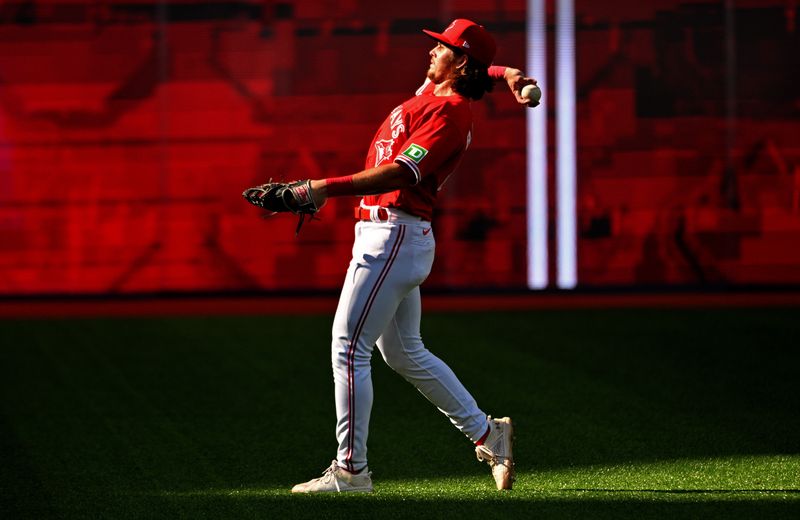 Jul 1, 2024; Toronto, Ontario, CAN;   Toronto Blue Jays left fielder Addison Barger (47) throws a ball to fans as he prepares for play in the ninth inning against the Houston Astros at Rogers Centre. Mandatory Credit: Dan Hamilton-USA TODAY Sports