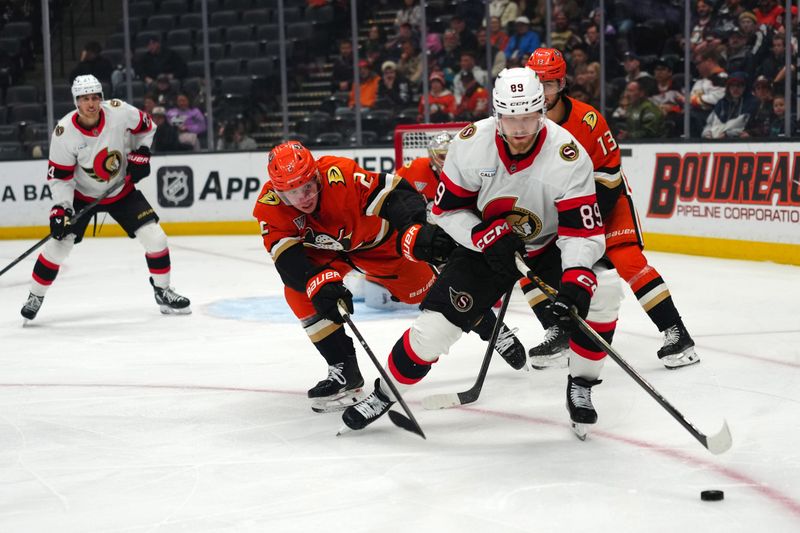Nov 20, 2025; Anaheim, California, USA; Ottawa Senators center Lars Eller (89) and Anaheim Ducks defenseman Jackson Lacombe (2) battle for the puck in the first period at Honda Center. Mandatory Credit: Kirby Lee-Imagn Images