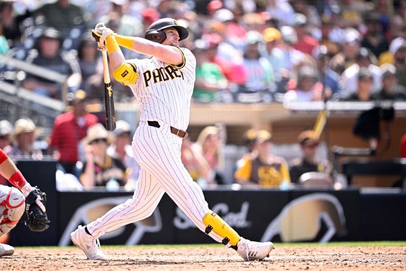 May 1, 2024; San Diego, California, USA; San Diego Padres first baseman Jake Cronenworth (9) hits a grand slam home run against the Cincinnati Reds during the seventh inning at Petco Park. Mandatory Credit: Orlando Ramirez-USA TODAY Sports