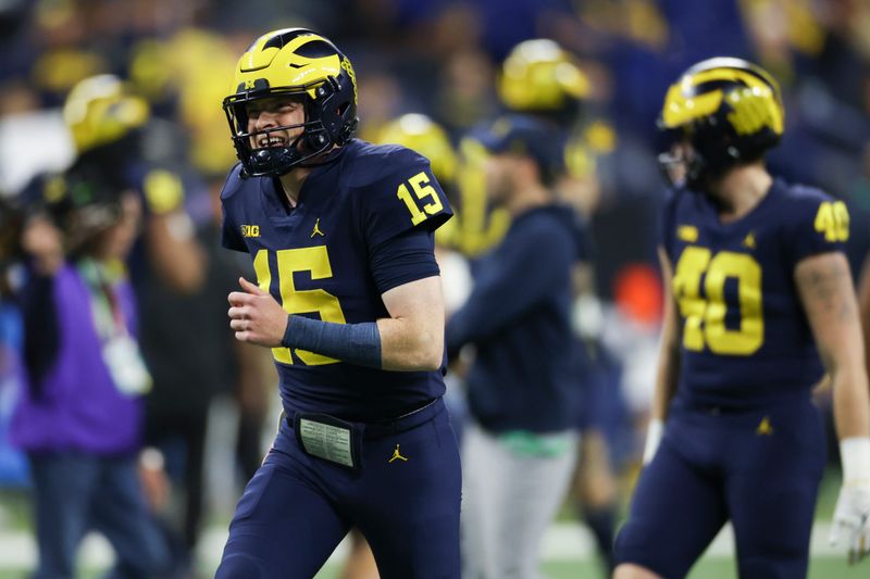 Dec 3, 2022; Indianapolis, Indiana, USA; Michigan Wolverines quarterback Alan Bowman (15) before the Big Ten Championship against the Purdue Boilermakers at Lucas Oil Stadium. Mandatory Credit: Trevor Ruszkowski-USA TODAY Sports