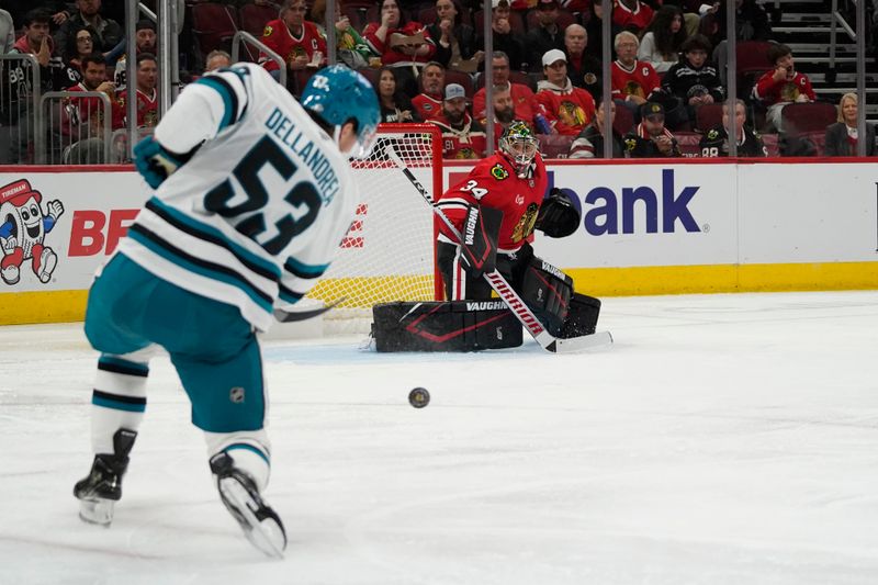 Oct 17, 2024; Chicago, Illinois, USA; San Jose Sharks center Ty Dellandrea (53) shoots the puck on Chicago Blackhawks goaltender Petr Mrazek (34) during the second period at United Center. Mandatory Credit: David Banks-Imagn Images