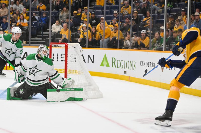 Oct 26, 2025; Nashville, Tennessee, USA;  Dallas Stars goaltender Casey Desmith (1) blocks the shot of Nashville Predators right wing Michael McCarron (47) during the third period at Bridgestone Arena. Mandatory Credit: Steve Roberts-Imagn Images
