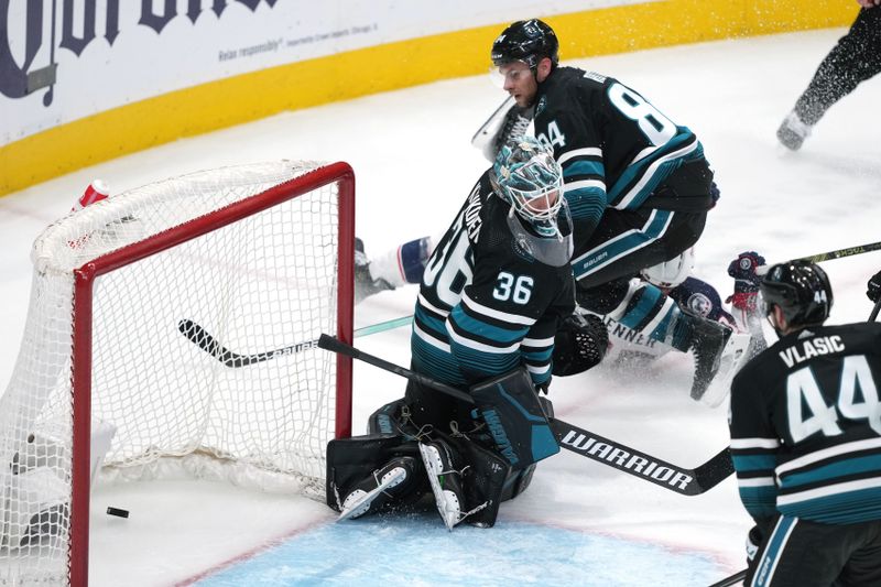 Feb 17, 2024; San Jose, California, USA; San Jose Sharks goaltender Kaapo Kahkonen (36) surrenders a goal to Columbus Blue Jackets center Boone Jenner (obscured) during the third period at SAP Center at San Jose. Mandatory Credit: Darren Yamashita-USA TODAY Sports