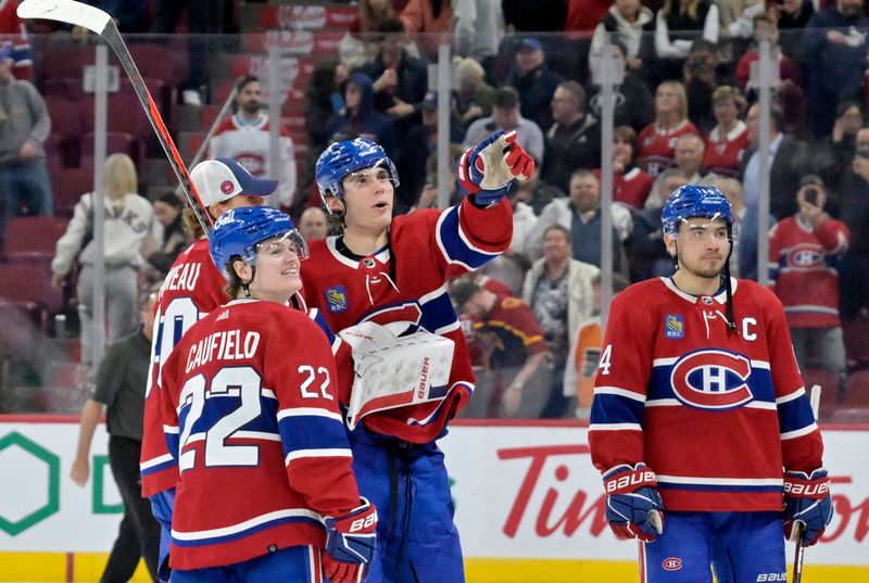 Apr 9, 2024; Montreal, Quebec, CAN; Montreal Canadiens forward Cole Caufield (22) and teammate forward Juraj Slafkovsky (20) celebrate the win against the Philadelphia Flyers at the Bell Centre. Mandatory Credit: Eric Bolte-USA TODAY Sports