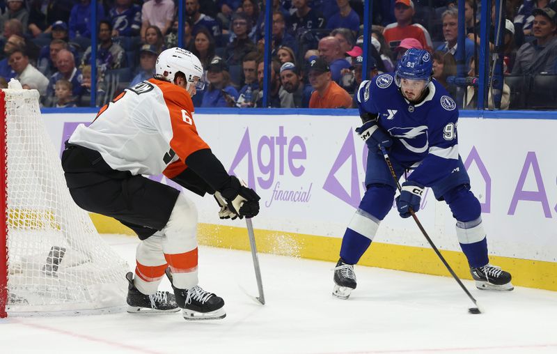 Nov 24, 2025; Tampa, Florida, USA; Tampa Bay Lightning center Gage Goncalves (93) skates with the puck as Philadelphia Flyers defenseman Travis Sanheim (6) defends during the first period at Benchmark International Arena. Mandatory Credit: Kim Klement Neitzel-Imagn Images