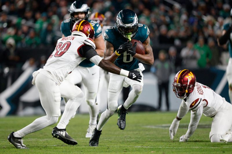 Philadelphia Eagles wide receiver DeVonta Smith (6) runs as Washington Commanders safety Quan Martin (20) defends during the first half of an NFL football game Thursday, Nov. 14, 2024, in Philadelphia. (AP Photo/Laurence Kesterson)