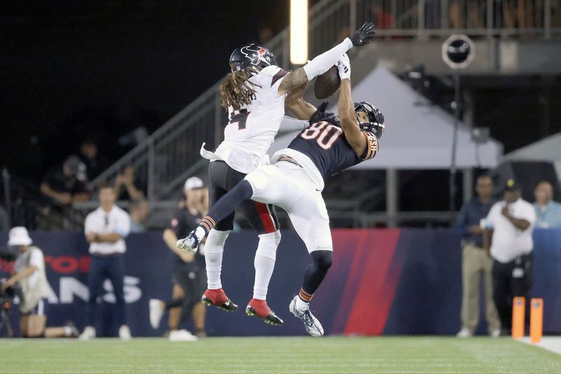 Chicago Bears wide receiver Collin Johnson (80) makes a catch while being defended by Houston Texans cornerback Mike Ford (4) during an NFL preseason football game, Thursday Aug. 21, 2024, in Canton, Ohio. (AP Photo/Kirk Irwin)