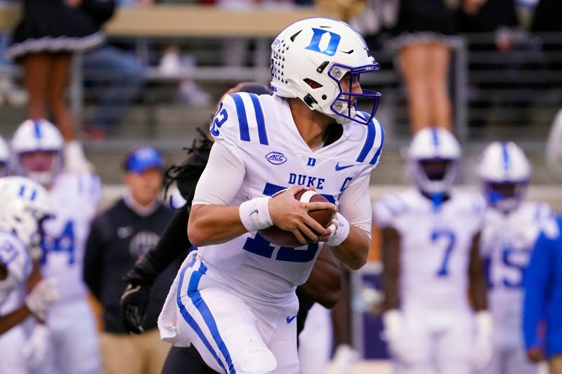 Oct 30, 2021; Winston-Salem, North Carolina, USA; Duke Blue Devils quarterback Gunnar Holmberg (12) rolls out of the pocket against the Wake Forest Demon Deacons during the second half at Truist Field. Mandatory Credit: James Guillory-USA TODAY Sports