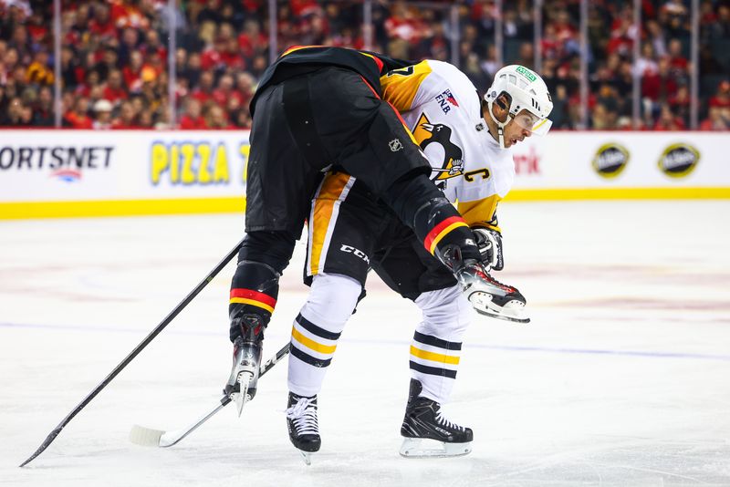 Oct 22, 2024; Calgary, Alberta, CAN; Pittsburgh Penguins center Sidney Crosby (87) and Calgary Flames center Jonathan Huberdeau (10) collides during the first period at Scotiabank Saddledome. Mandatory Credit: Sergei Belski-Imagn Images