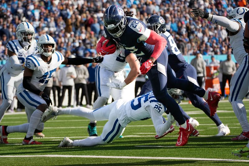 Tennessee Titans running back Derrick Henry (22) dives into the end zone for a touchdown past Indianapolis Colts safety Rodney Thomas II (25) during the first half of an NFL football game Sunday, Dec. 3, 2023, in Nashville, Tenn. (AP Photo/George Walker IV)