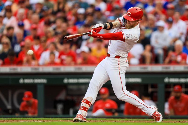 Jul 29, 2024; Cincinnati, Ohio, USA; Cincinnati Reds outfielder Jake Fraley (27) hits a single in the second inning against the Chicago Cubs at Great American Ball Park. Mandatory Credit: Katie Stratman-USA TODAY Sports