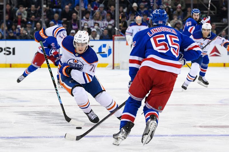 Dec 22, 2023; New York, New York, USA;  Edmonton Oilers center Ryan McLeod (71) skates against New York Rangers defenseman Ryan Lindgren (55) during the third period at Madison Square Garden. Mandatory Credit: Dennis Schneidler-USA TODAY Sports