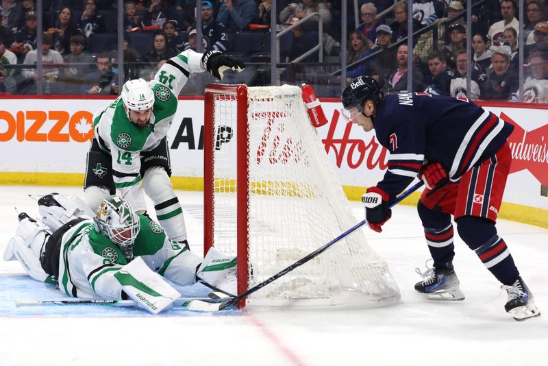 Nov 9, 2024; Winnipeg, Manitoba, CAN;  Winnipeg Jets center Vladislav Namestnikov (7) tries a wrap around against Dallas Stars goaltender Jake Oettinger (29) in the second period at Canada Life Centre. Mandatory Credit: James Carey Lauder-Imagn Images