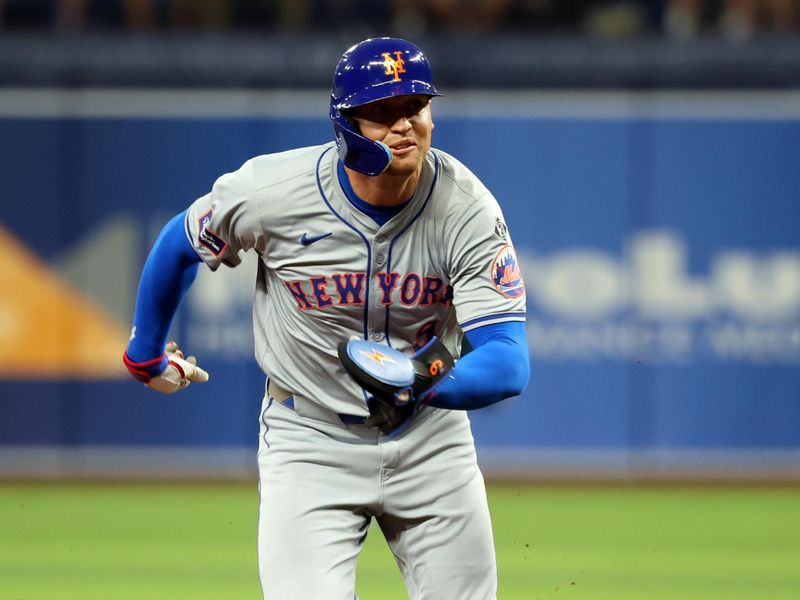 May 4, 2024; St. Petersburg, Florida, USA;  New York Mets outfielder Brandon Nimmo (9) runs home to score a run against the Tampa Bay Rays during the first inning at Tropicana Field. Mandatory Credit: Kim Klement Neitzel-USA TODAY Sports