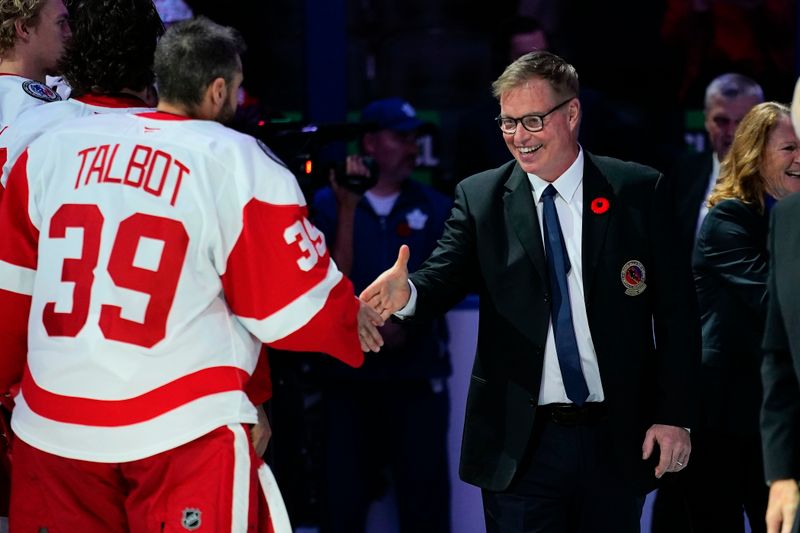 Nov 8, 2024; Toronto, Ontario, CAN; Hockey Hall of Fame inductee member Larry Murphy (right) greets Detroit Red Wings goaltender Cam Talbot (39) before a game against the Toronto Maple Leafs at Scotiabank Arena. Mandatory Credit: John E. Sokolowski-Imagn Images