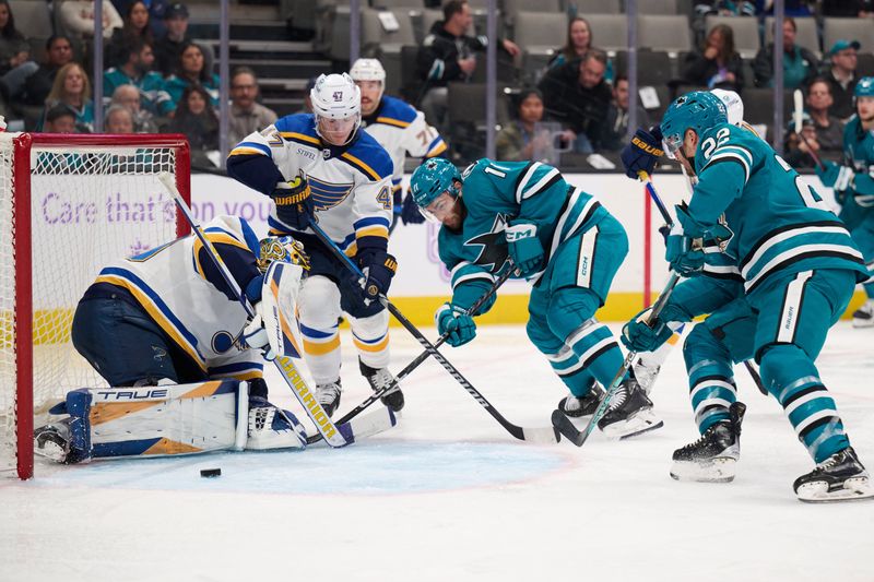 Nov 16, 2023; San Jose, California, USA; San Jose Sharks center Luke Kunin (11) shoots the puck against St. Louis Blues goaltender Joel Hofer (30) during the second period at SAP Center at San Jose. Mandatory Credit: Robert Edwards-USA TODAY Sports