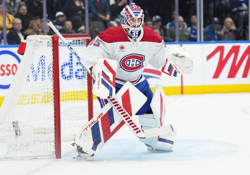 Nov 9, 2024; Toronto, Ontario, CAN; Montreal Canadiens goaltender Sam Montembeault (35) follows the play against the Toronto Maple Leafs during the first period at Scotiabank Arena. Mandatory Credit: Nick Turchiaro-Imagn Images