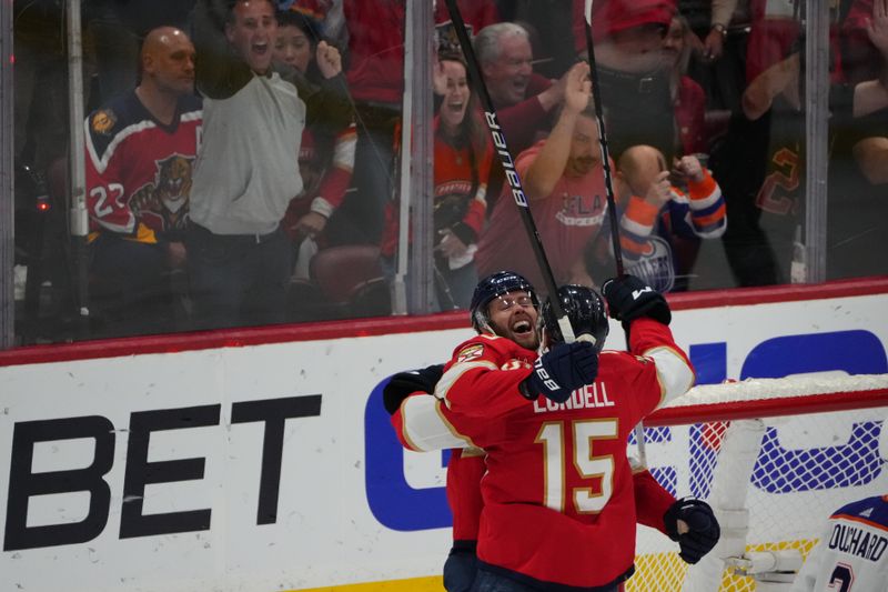 Jun 24, 2024; Sunrise, Florida, USA; Florida Panthers forward Carter Verhaeghe (23) celebrates scoring with forward Anton Lundell (15) against Edmonton Oilers goaltender Skinner Stuart (74) during the first period in game seven of the 2024 Stanley Cup Final at Amerant Bank Arena. Mandatory Credit: Jim Rassol-USA TODAY Sports