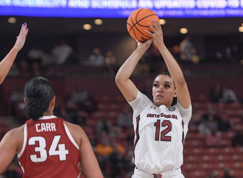 Mar 3, 2023; Greenville, SC, USA; South Carolina guard Brea Beal (12) shoots near Arkansas guard Chrissy Carr (34) during the first quarter at Bon Secours Wellness Arena. Mandatory Credit: Ken Ruinard-USA TODAY Sports