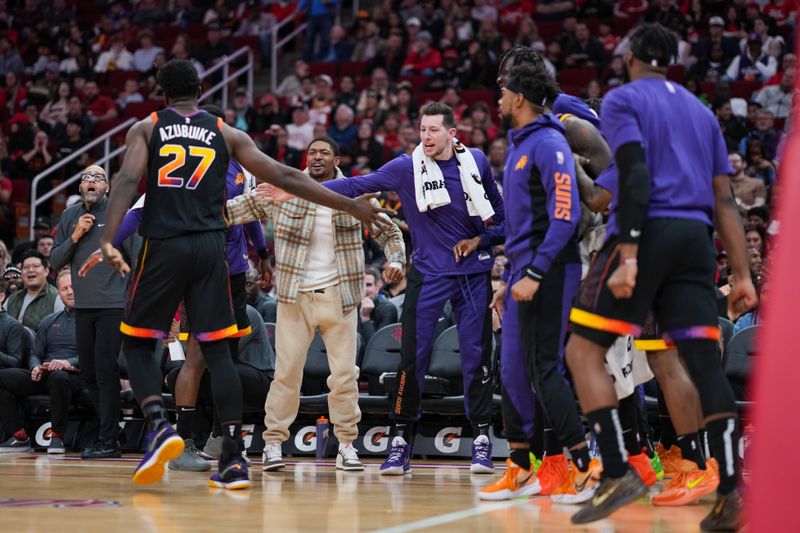 HOUSTON, TEXAS - DECEMBER 27: The Phoenix Suns bench reacts after Udoka Azubuike #27 of the Phoenix Suns scores during the second half of the game against the Houston Rockets at Toyota Center on December 27, 2023 in Houston, Texas. User expressly acknowledges and agrees that, by downloading and or using this photograph, User is consenting to the terms and conditions of the Getty Images License Agreement. (Photo by Alex Bierens de Haan/Getty Images)