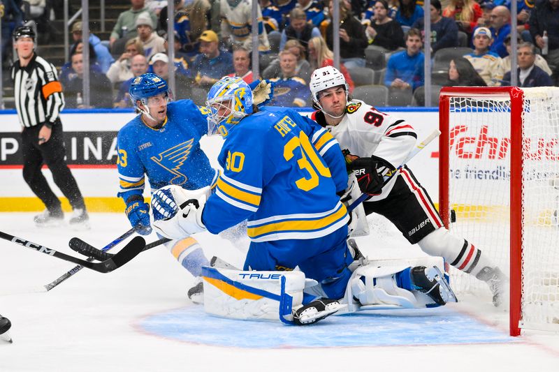 Oct 15, 2025; St. Louis, Missouri, USA; Chicago Blackhawks center Frank Nazar (91) collides with St. Louis Blues goaltender Joel Hofer (30) after scoring during the second period at Enterprise Center. Mandatory Credit: Jeff Curry-Imagn Images