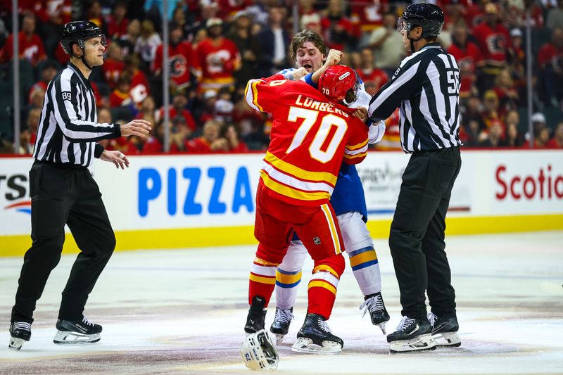 Oct 11, 2025; Calgary, Alberta, CAN; Calgary Flames left wing Ryan Lomberg (70) and St. Louis Blues defenseman Tyler Tucker (75) fights during the second period at Scotiabank Saddledome. Mandatory Credit: Sergei Belski-Imagn Images