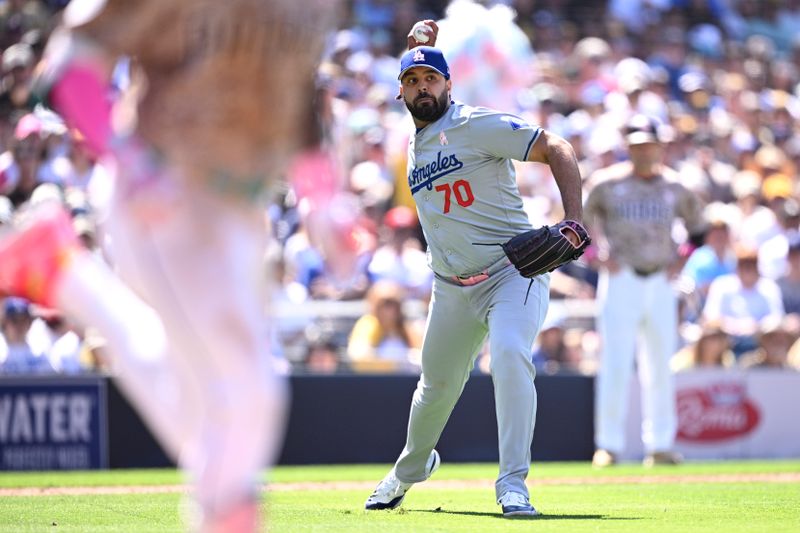 May 12, 2024; San Diego, California, USA; Los Angeles Dodgers relief pitcher Nabil Crismatt (70) throws to first base on a ground out by San Diego Padres left fielder Jurickson Profar (left) during the seventh inning at Petco Park. Mandatory Credit: Orlando Ramirez-USA TODAY Sports