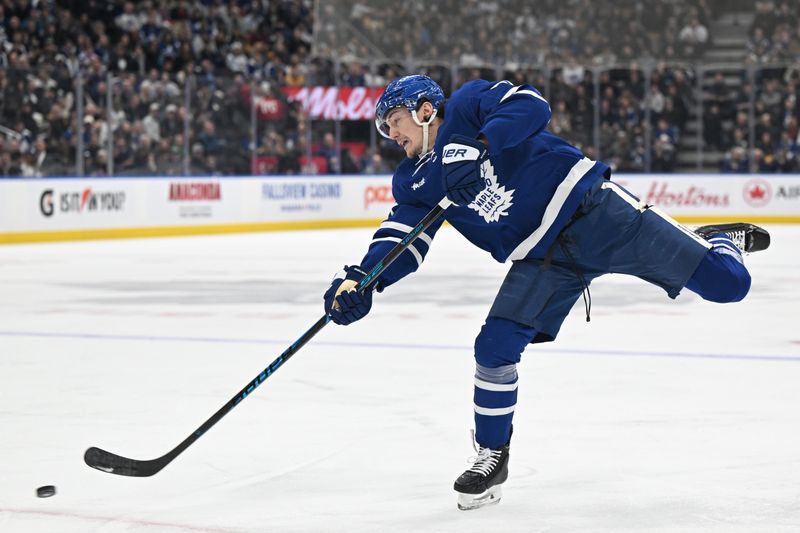 Dec 23, 2025; Toronto, Ontario, CAN;  Toronto Maple Leafs defenseman Phillipe Myers (51) shoots the puck against the Pittsburgh Penguins in the first period at Scotiabank Arena. Mandatory Credit: Dan Hamilton-Imagn Images